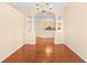 Formal dining room with hardwood floors and a view into the kitchen at 4201 Silver Berry Ct, Spring Hill, FL 34609