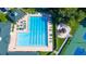 Community pool with surrounding lounge chairs and playground at 4201 Silver Berry Ct, Spring Hill, FL 34609