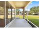 Spacious screened porch overlooking a grassy backyard at 4201 Silver Berry Ct, Spring Hill, FL 34609