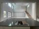 Kitchen island with gray countertop overlooking the living room at 5252 Ravensbrook Ct, Brooksville, FL 34601