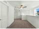 Bright hallway with carpeted floor and two doors at 6688 Back Forty Loop, Zephyrhills, FL 33541