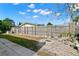 Large backyard with a fire pit and a wooden fence at 7311 Coventry Dr, Port Richey, FL 34668