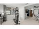 Home exercise room with elliptical machine and kitchen view at 7311 Coventry Dr, Port Richey, FL 34668