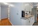 Kitchen hallway with granite countertops and white cabinets at 7347 Sugarbush Dr, Spring Hill, FL 34606