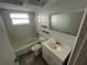 Bathroom featuring a tub, toilet, vanity and wall mirror at 7552 Cumber Dr, New Port Richey, FL 34653