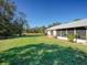 Large backyard with grassy area and screened patio at 8500 Forest Glade Dr, Hudson, FL 34667