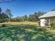 Spacious backyard with grassy lawn and screened patio at 8500 Forest Glade Dr, Hudson, FL 34667