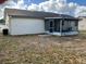 View of the back of the house with a screened in porch at 8525 Gandy Ln, Port Richey, FL 34668