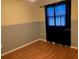 Well-lit bedroom featuring wood flooring and window at 8525 Gandy Ln, Port Richey, FL 34668