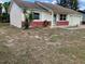 Ranch home with a brick facade and a large yard at 8525 Gandy Ln, Port Richey, FL 34668