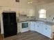 Modern kitchen with white cabinets, granite countertops and stainless steel appliances at 8525 Gandy Ln, Port Richey, FL 34668