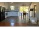 Open concept kitchen with white cabinets, a breakfast bar, and access to the patio at 8525 Gandy Ln, Port Richey, FL 34668