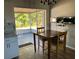 Kitchen with table and access to screened porch at 8525 Gandy Ln, Port Richey, FL 34668