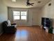 Bright living room with hardwood floors and large windows at 8525 Gandy Ln, Port Richey, FL 34668