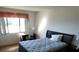 Bright bedroom with a double bed, desk, and window overlooking a grassy area at 9980 Eagles Point Cir # 3, Port Richey, FL 34668