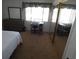 Bright bedroom with a bed, desk, and mirrored closet at 9980 Eagles Point Cir # 3, Port Richey, FL 34668