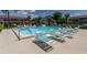 Community pool with multiple lounge chairs for relaxing at 9980 Eagles Point Cir # 3, Port Richey, FL 34668