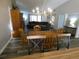 Dining area with wood table, chandelier and kitchen passthrough at 9980 Eagles Point Cir # 3, Port Richey, FL 34668