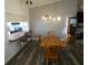 Dining area with wood table, chandelier, and kitchen view at 9980 Eagles Point Cir # 3, Port Richey, FL 34668