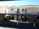 Condo building with carport and stairs leading to entrance at 9980 Eagles Point Cir # 3, Port Richey, FL 34668