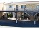 Exterior view of the condo building with carport and stairs at 9980 Eagles Point Cir # 3, Port Richey, FL 34668