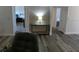 Hallway with wood-look floors and views into the bedroom and bathroom at 9980 Eagles Point Cir # 3, Port Richey, FL 34668