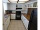 Kitchen with white cabinets, wood countertops, and black appliances at 9980 Eagles Point Cir # 3, Port Richey, FL 34668