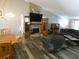 Living room with stone fireplace, wood flooring and sectional sofa at 9980 Eagles Point Cir # 3, Port Richey, FL 34668