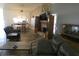 Open living room and dining area with gray sectional sofa and a fireplace at 9980 Eagles Point Cir # 3, Port Richey, FL 34668