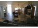 Open living room and dining area with gray sectional sofa and a fireplace at 9980 Eagles Point Cir # 3, Port Richey, FL 34668