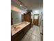 Double vanity bathroom with wood cabinets and tiled floor at 1000 Godfrey Ave, Spring Hill, FL 34609