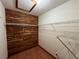 Walk-in closet featuring a cedar wall, shelving and laminate flooring at 1000 Godfrey Ave, Spring Hill, FL 34609