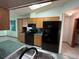 Features wood cabinets, black appliances, green countertops, tiled floors and skylights at 1000 Godfrey Ave, Spring Hill, FL 34609