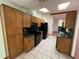 The kitchen has wood cabinets, black appliances, green countertops and tiled floors at 1000 Godfrey Ave, Spring Hill, FL 34609
