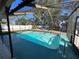 Inviting screened-in pool with cool blue water and relaxation-ready hammocks at 1000 Godfrey Ave, Spring Hill, FL 34609