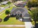 Single-story house with a dark gray roof, screened pool, and attached garage at 10464 Henderson St, Spring Hill, FL 34608