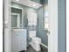 Small, updated bathroom with gray walls and white vanity at 10464 Henderson St, Spring Hill, FL 34608
