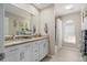 Bathroom with double vanity, granite countertop and bathtub at 10464 Henderson St, Spring Hill, FL 34608