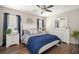 Well-lit bedroom with a queen-size bed and white dresser at 10464 Henderson St, Spring Hill, FL 34608