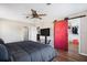 Spacious bedroom with a red barn door leading to a large closet at 10464 Henderson St, Spring Hill, FL 34608