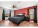King-size bed in a spacious bedroom with wood floors at 10464 Henderson St, Spring Hill, FL 34608