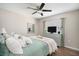 Bright bedroom with a queen bed, dresser, and ceiling fan at 10464 Henderson St, Spring Hill, FL 34608