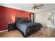 Bright bedroom with a king-size bed and red accent wall at 10464 Henderson St, Spring Hill, FL 34608