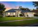 Attractive single-story home with a well-manicured lawn and landscape lighting at 10464 Henderson St, Spring Hill, FL 34608