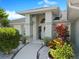 Welcoming front entry with a landscaped walkway and decorative planters at 10464 Henderson St, Spring Hill, FL 34608