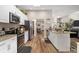 Modern kitchen with white cabinets, granite counters, and stainless steel appliances at 10464 Henderson St, Spring Hill, FL 34608