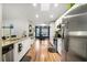 Modern kitchen with white cabinets, granite counters, and stainless steel appliances at 10464 Henderson St, Spring Hill, FL 34608
