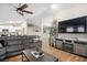 Spacious living room featuring a sectional sofa, large TV, and fireplace at 10464 Henderson St, Spring Hill, FL 34608