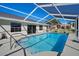 Enclosed rectangular pool with a concrete deck at 10464 Henderson St, Spring Hill, FL 34608