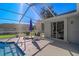 Relaxing poolside area with lounge chairs and umbrella at 10464 Henderson St, Spring Hill, FL 34608